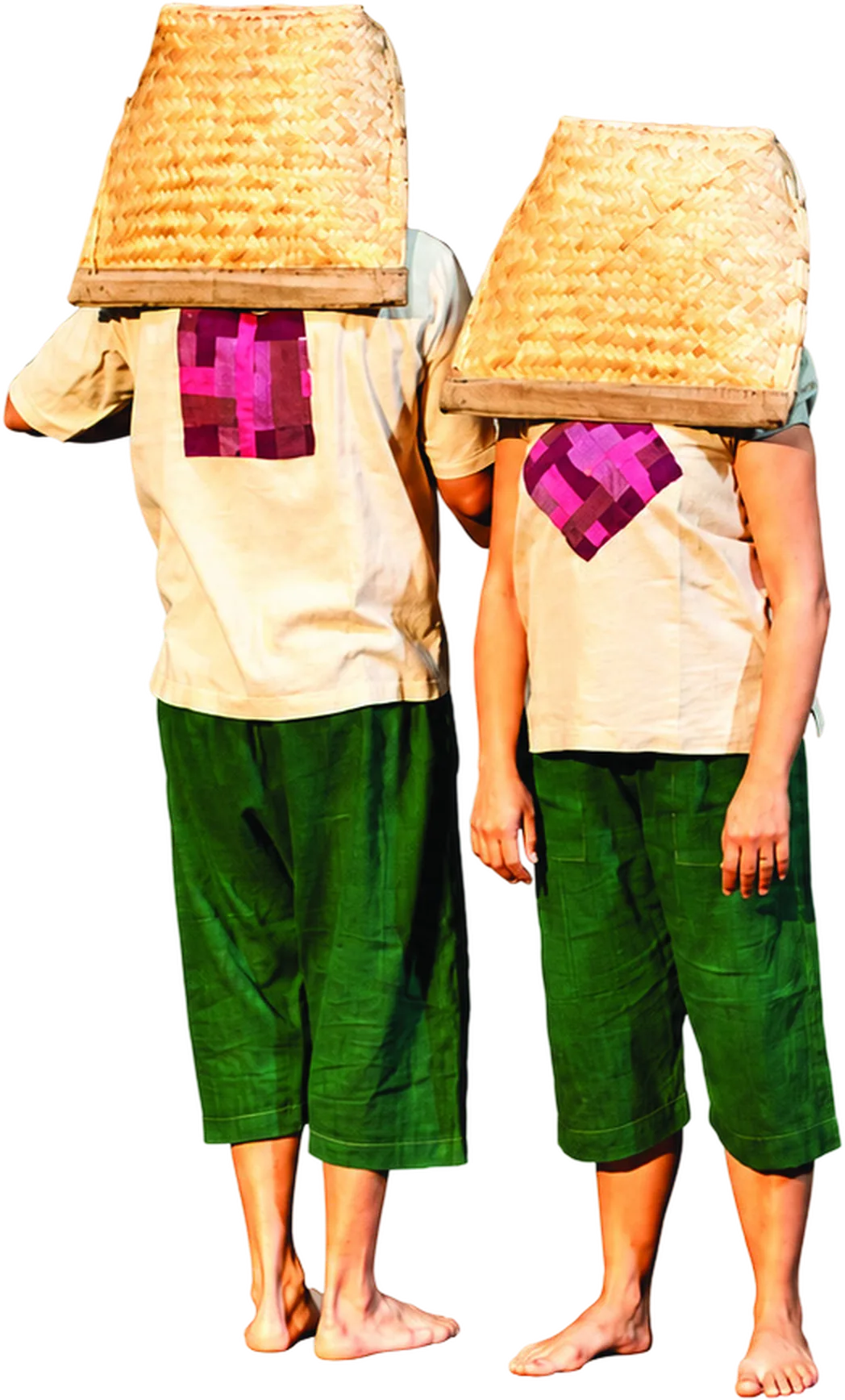 Two performers standing side by side with woven baskets over their heads.