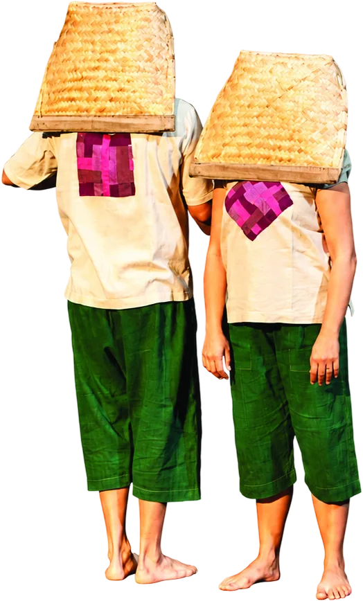Two performers standing side by side with woven baskets over their heads.