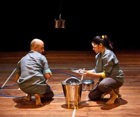 A single steel plate spinning on the floor.
